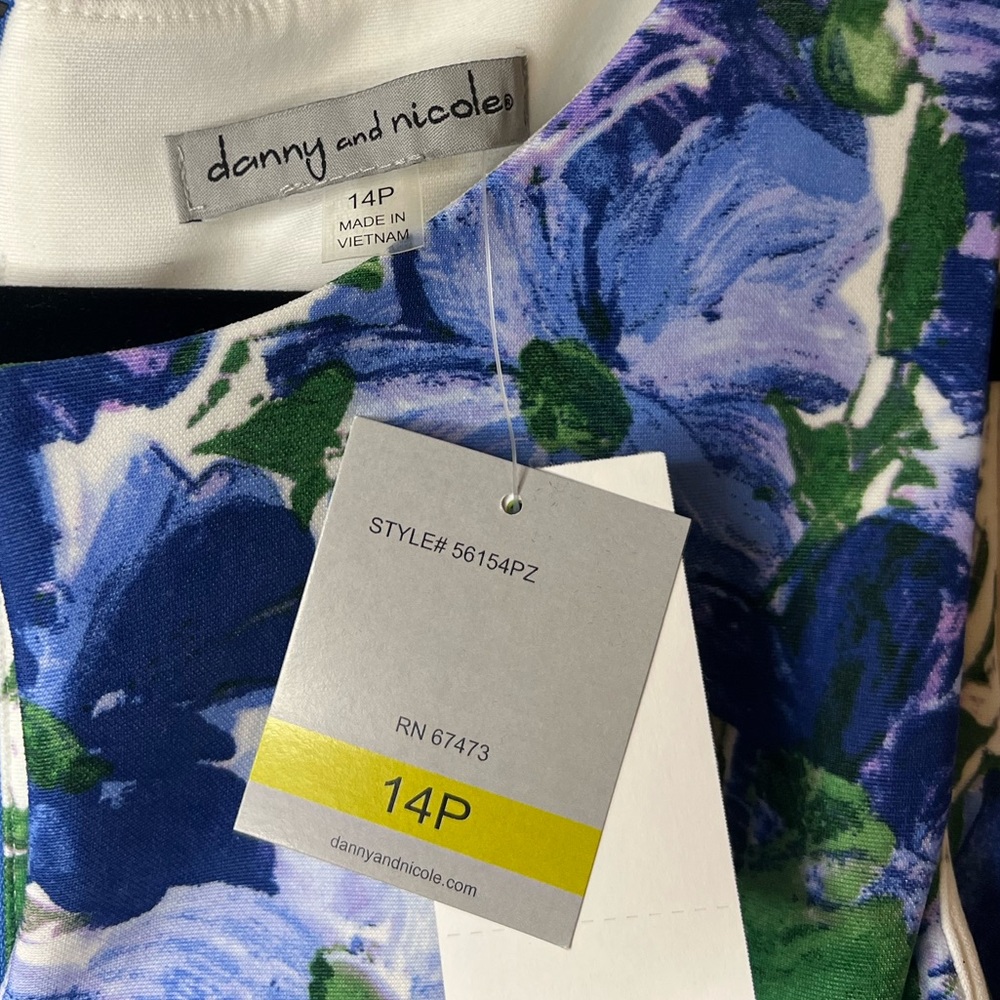 A blue and purple flower on white formal dress